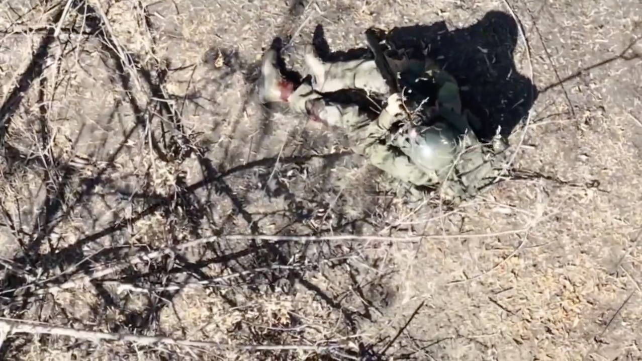 Russian is wounded in the leg by drone dropped grenade while running along the treeline. Shoots himself soon after