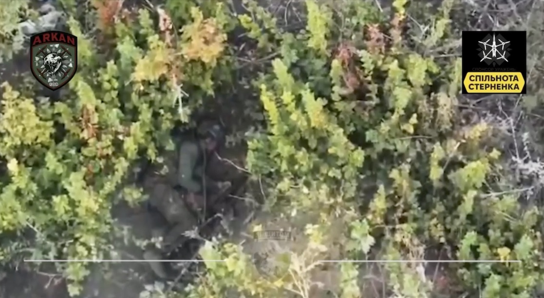 Russian soldier is seen shooting himself under the trees