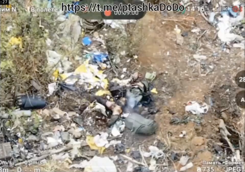 Russian soldier lies heavily injured among trash. Shoots himself to no immediate success