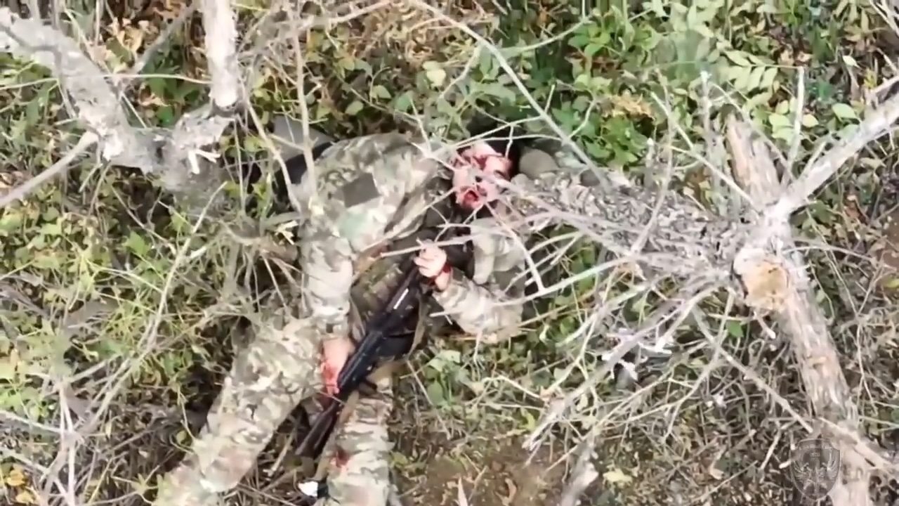 Wounded Russian lying on his back shoots himself in the head under chin to little effect, repositions and shoots again