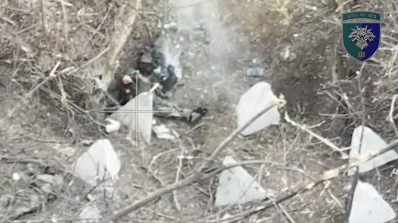 Russian receives multiple hits nearby while hiding among dragon teeth. Reportedly decides to detonate his own grenade