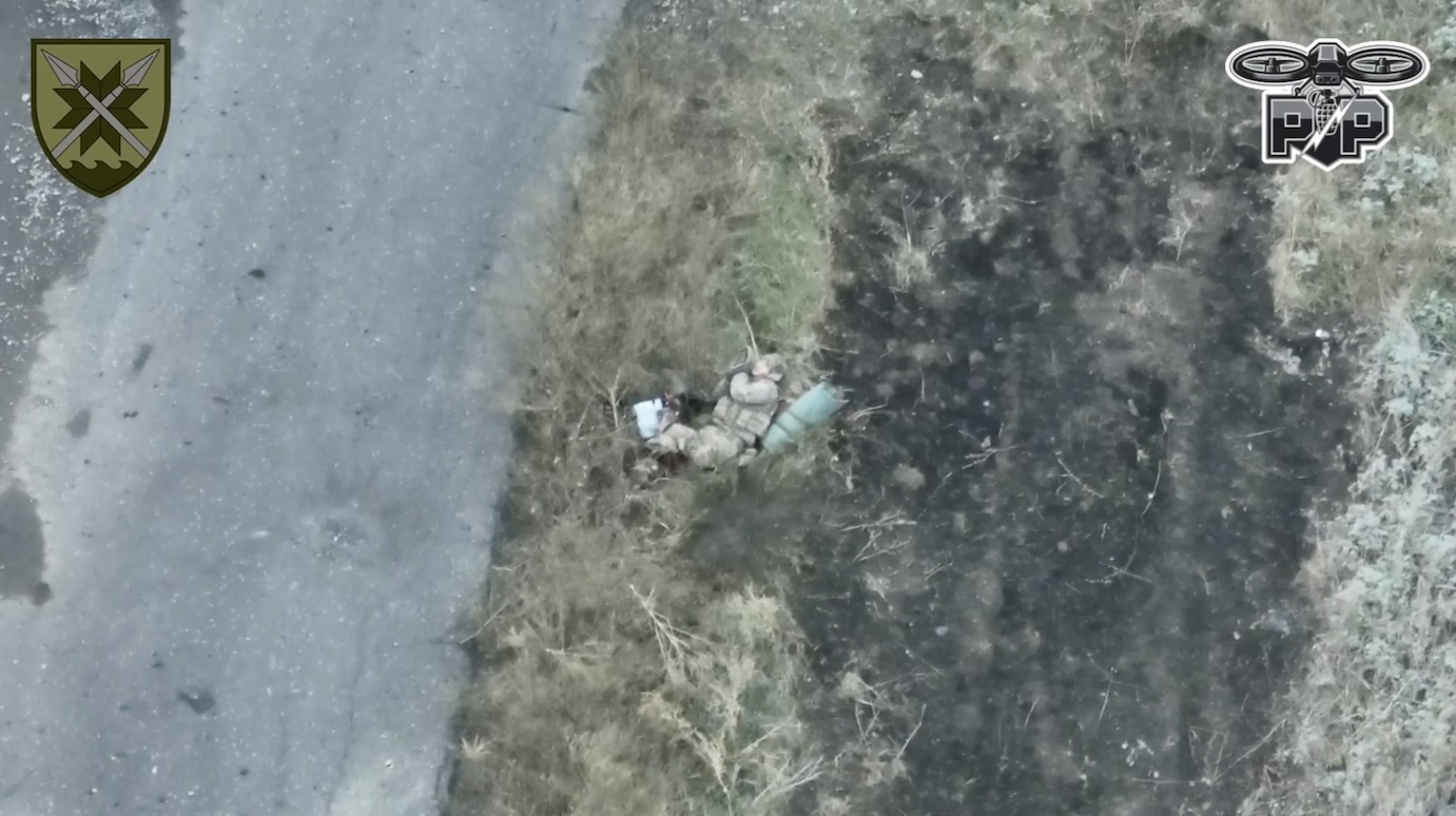 Russian is under drone drop attack while walking along the road. After another direct hit, severely wounded, he decides to blow up grenade to his neck