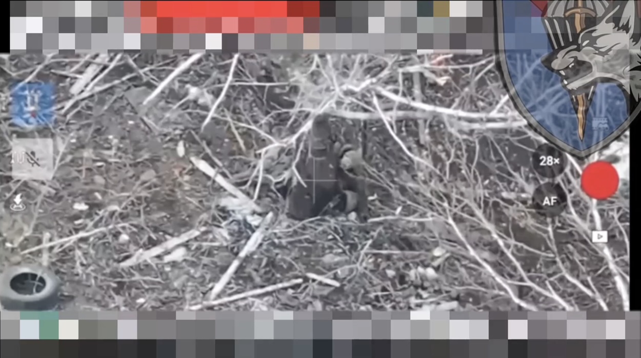 Russian appears to shoot himself while lying on his side behind some object