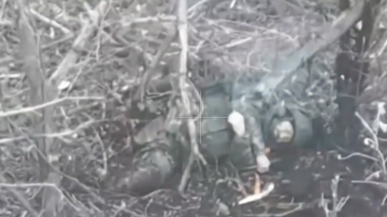 Russian lying on his side pulls pin on hand grenade, and leaves it on top of his head to detonate