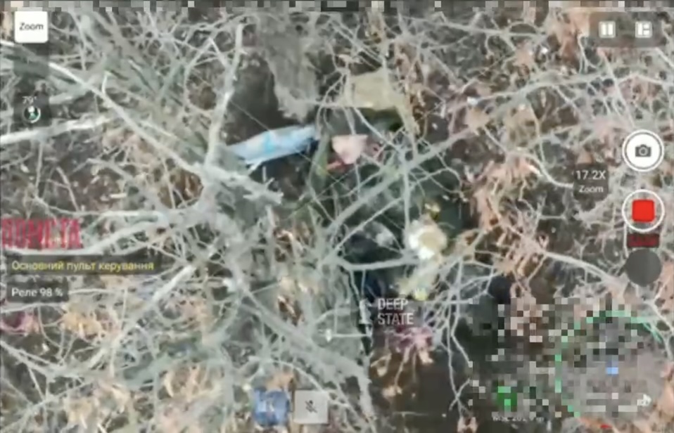 Russian is seen shooting himself under the tree. Unclear if intentionally or not, first attempt leaves him virtually unscathed. He proceeds with second attempt, this time lethal