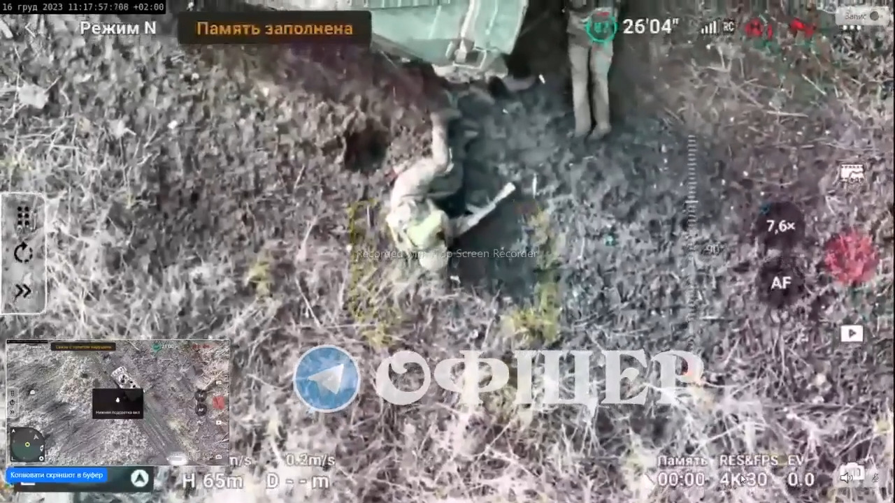 Russian soldier near vehicle is hit by drone dropped grenade. Shoots himself in head while laying feet from comrade