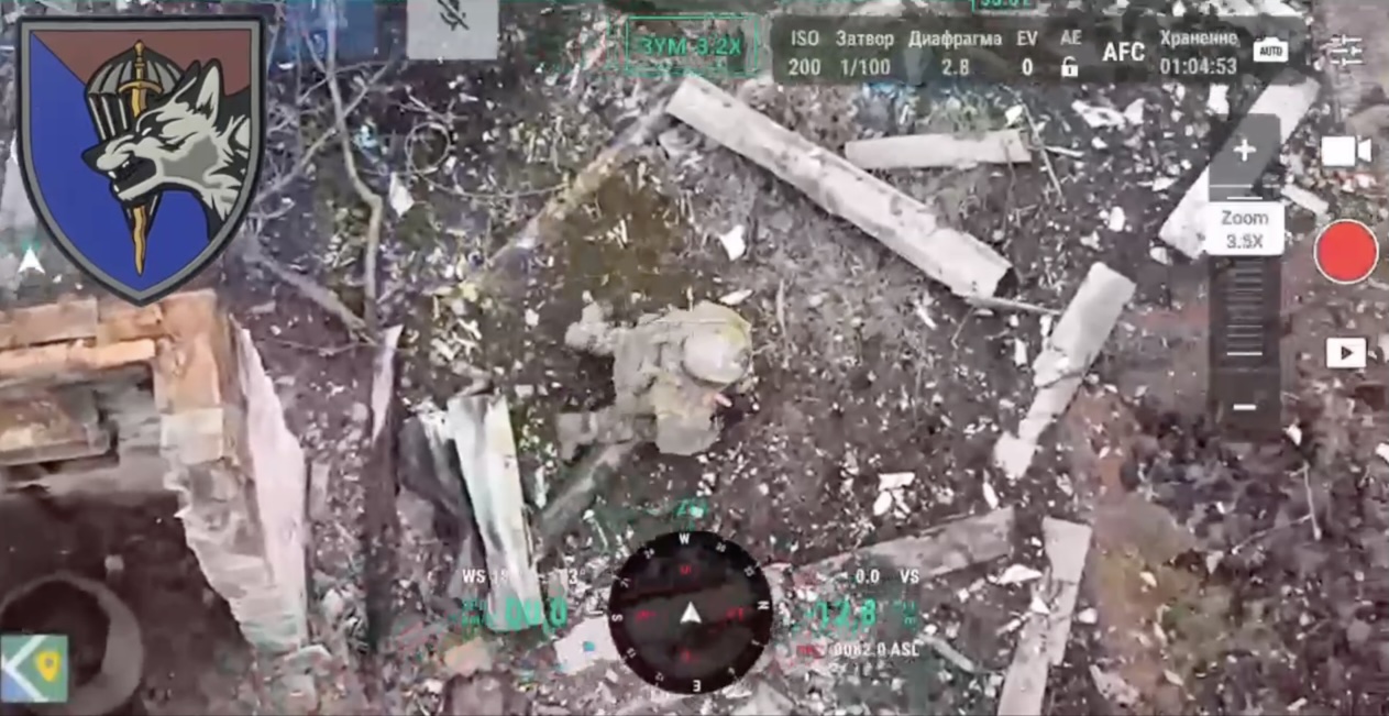 Russian soldier is observed from above walking among rubbles. As soon as he spots the drone he kneels and shoots himself in the head