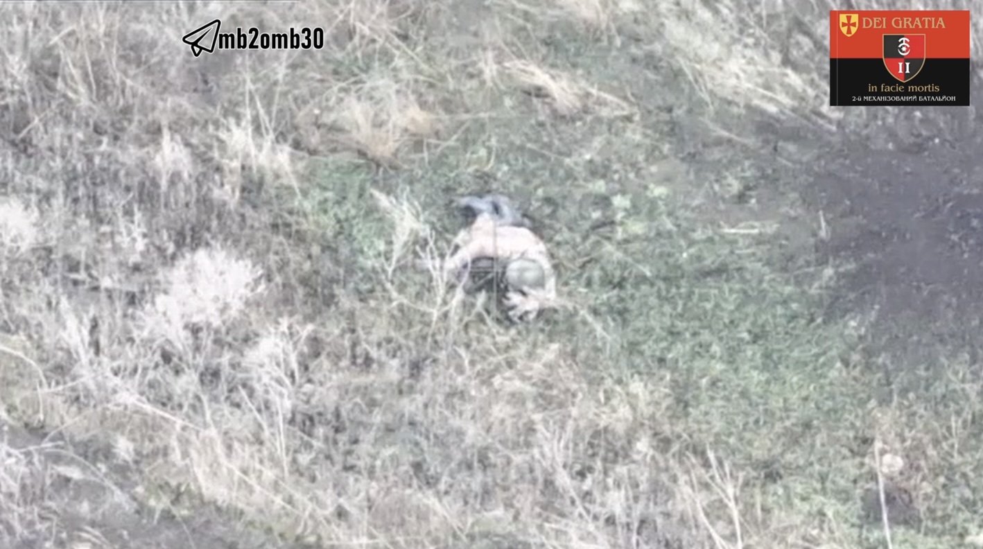 Russian soldier shoots himself while lying on his belly in the open near shell hole