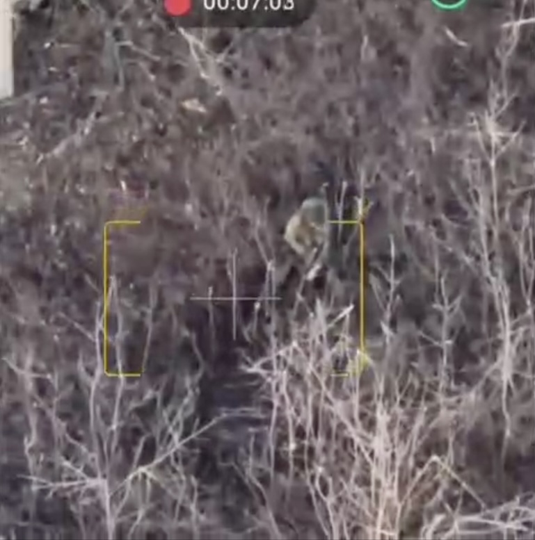 Russian sitting on the ground appears to shoot himself