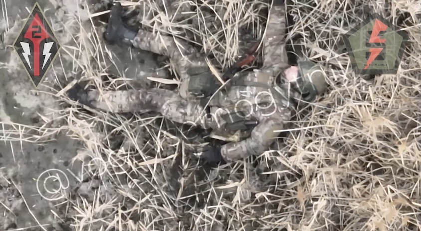 Fully equipped Russian soldier tries to shoot down drone that is dropping grenades on him, unsuccessfully. He grabs grenade, makes sure drone operator saw it, and proceeds with detonating it under his vest