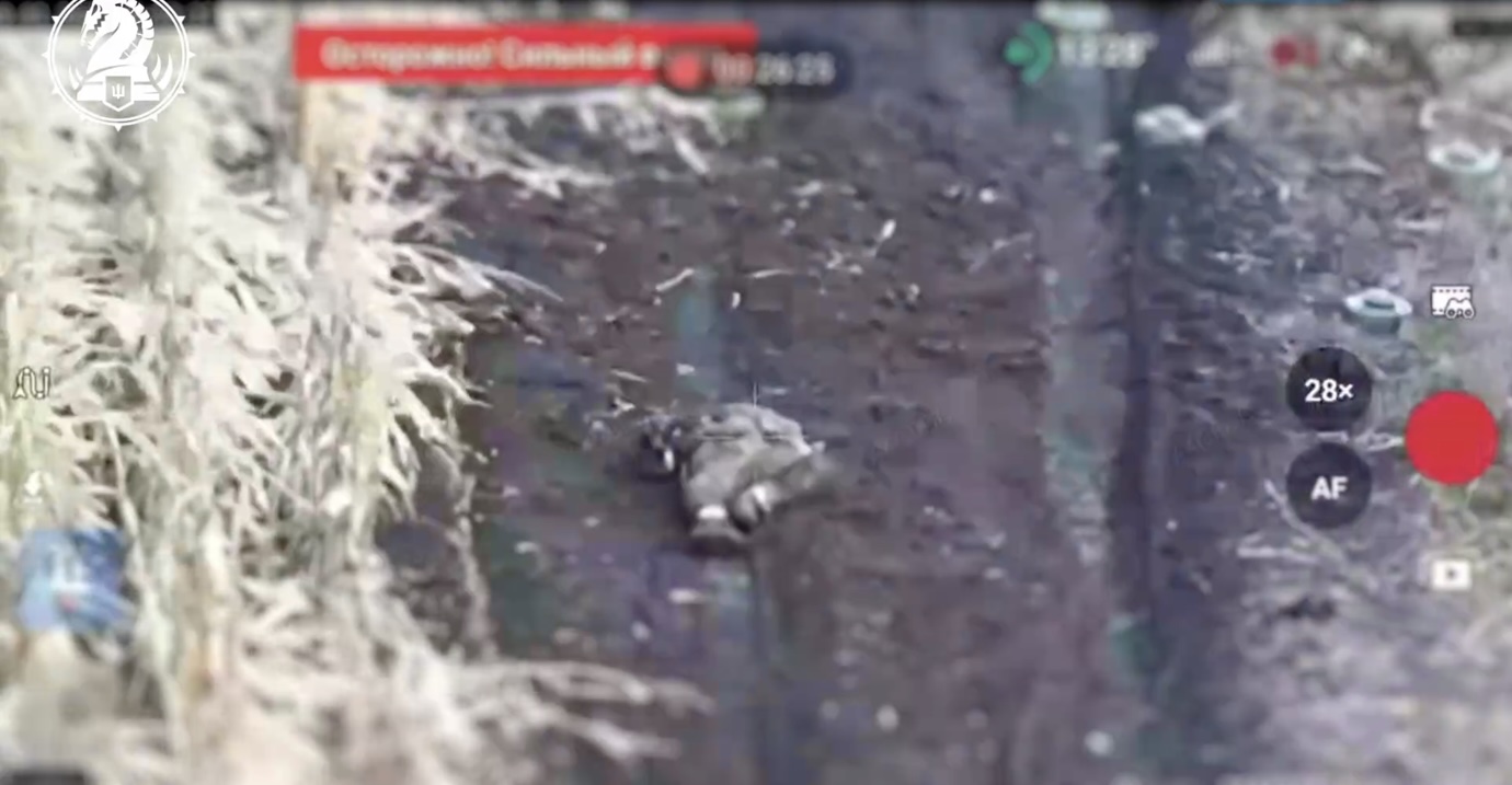 Russian is running down the road, suddenly lays down for no apparent reason and shoots himself. Close aftermath footage is present