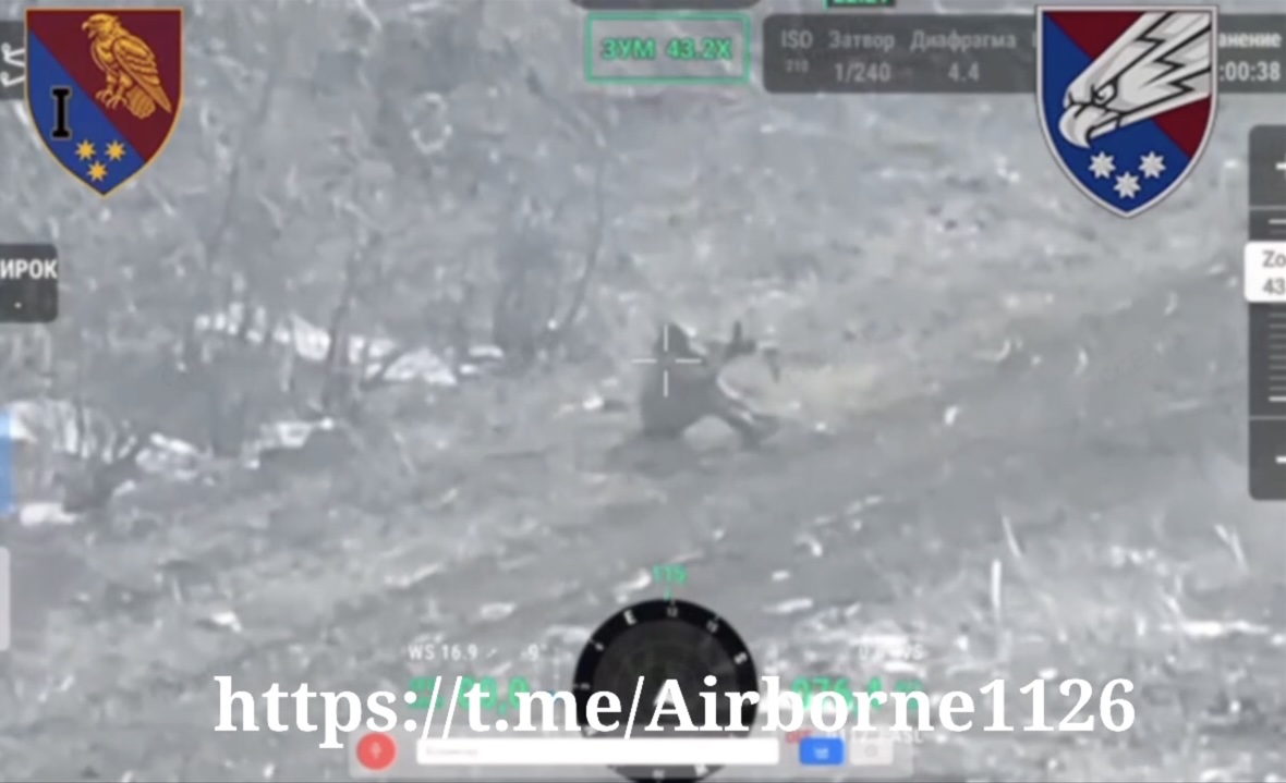 Russian is sitting on the ground by the road, first shoots from his AK in the air on full auto, then holds it in front of his face and shoots himself