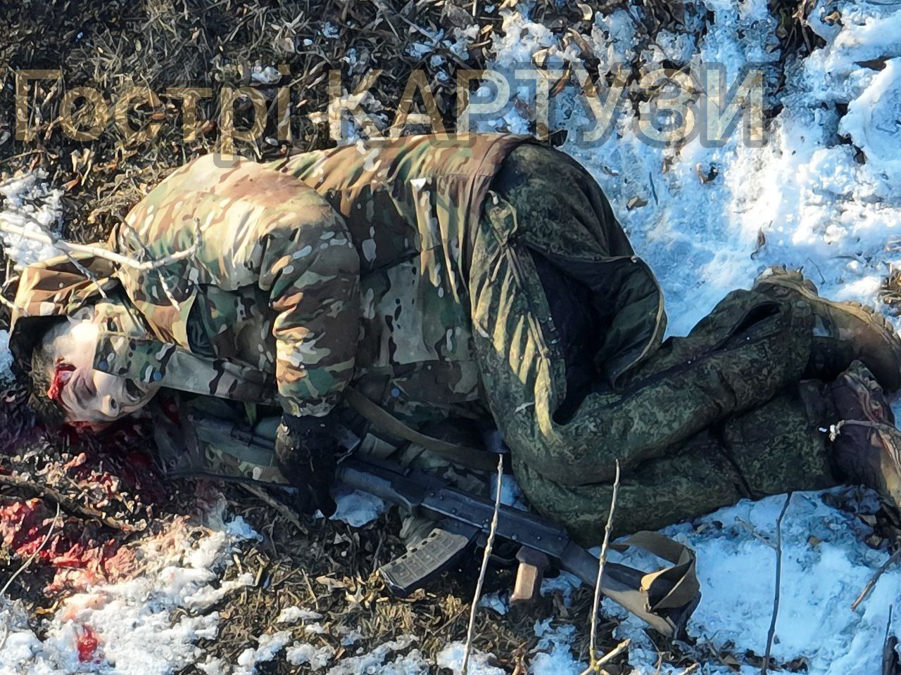 Graphic photo of Russian soldier who has apparently just shot himself, his rifle pointed at his face, and there's fresh hole in his temple
