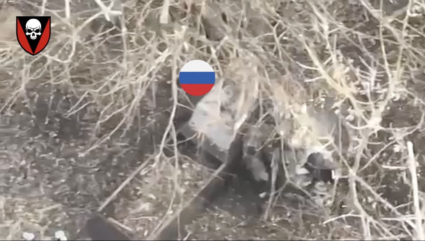 Brief cut featuring Russian soldier shooting himself with his AK on full auto while leaning against what looks like a grave