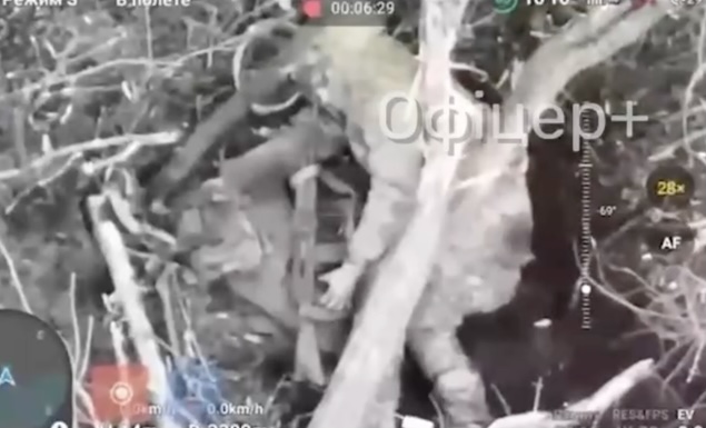 Russian is seen shooting himself in the head while lying on his side under tree branch