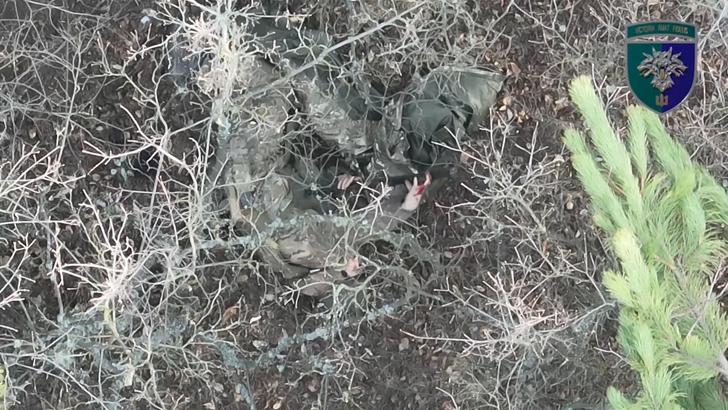 Russian is targeted by multiple drone drops, is seen lying on the ground and shooting himself in the heart twice, eventually appears dead