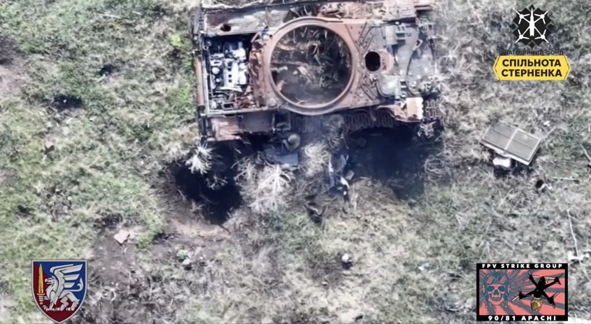 Russian soldier is hiding under old Ukrainian tank wreck, receives close FPV hit, grabs his AK, shoots himself and falls back