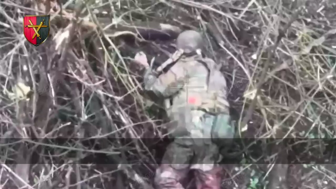 Injured Russian is lying on the ground face down, takes out his knife, after few moments of hesitation makes eye contact with drone and cuts veins on his wrist violently