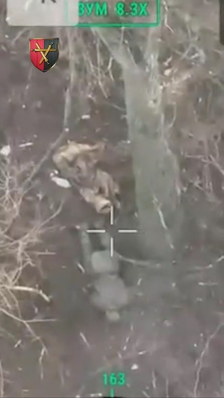 Russian under the tree appears to detonate grenade under himself lying face down, he seems to be blown away by an explosion