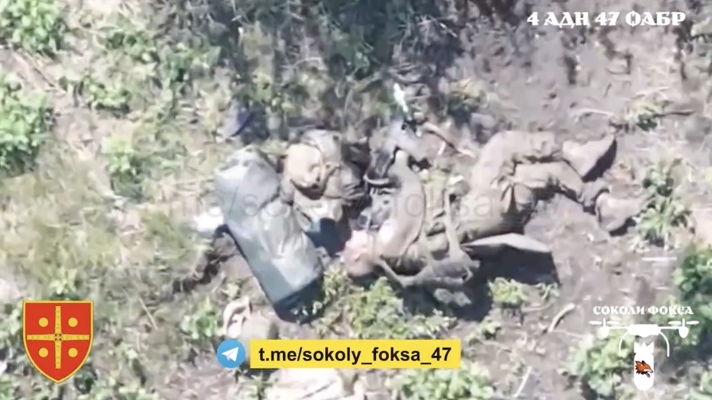 Russian is seen lying on the ground in a treeline shooting back at the drone above him. Few moments later he is being attacked with multiple grenades, camera zooms in on him apparently dead with his AK pointing at his chin