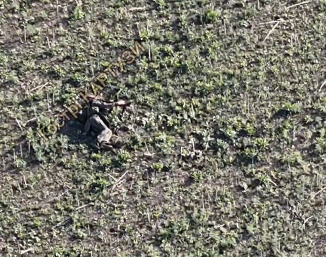 Fully equipped Russian soldier shoots himself while lying – presumably injured – in the open field