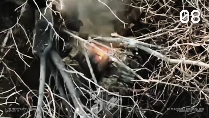 Same footage and possibly same scene as the previous case. Another Russian appears to detonate grenade under himself while something is burning besides him and drone passing by