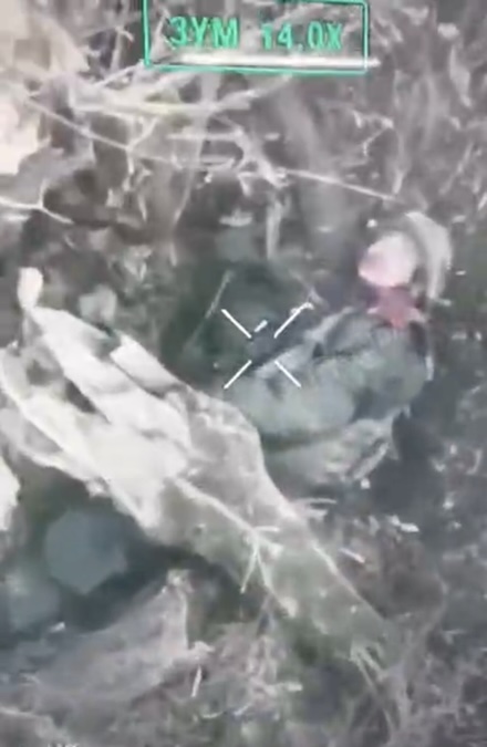 Russian soldier of what looks like asian descent shoots himself with AK pointing under his chin. After series of visible shots his helmet falls off but he's not immediately dead, and touches his head while slowly rolling onto his side