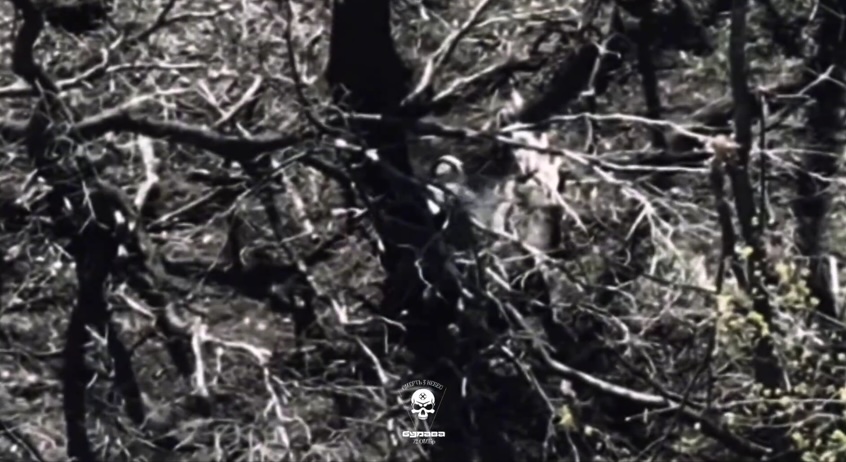 Russian soldier is seen shooting himself while lying under the tree, moments after drone passes by