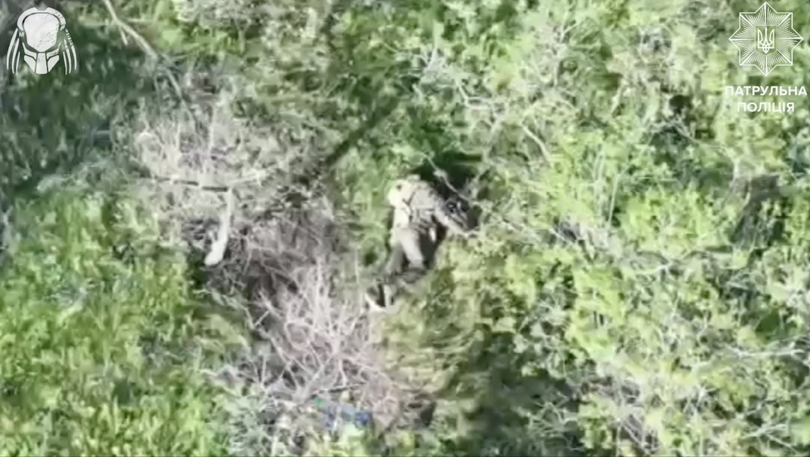 Russian soldier comes out of shelter and starts running, immediately followed by FPV that hits closely. Eventually is seen lying in the grass, apparently injured, and shooting himself while another drone flies by
