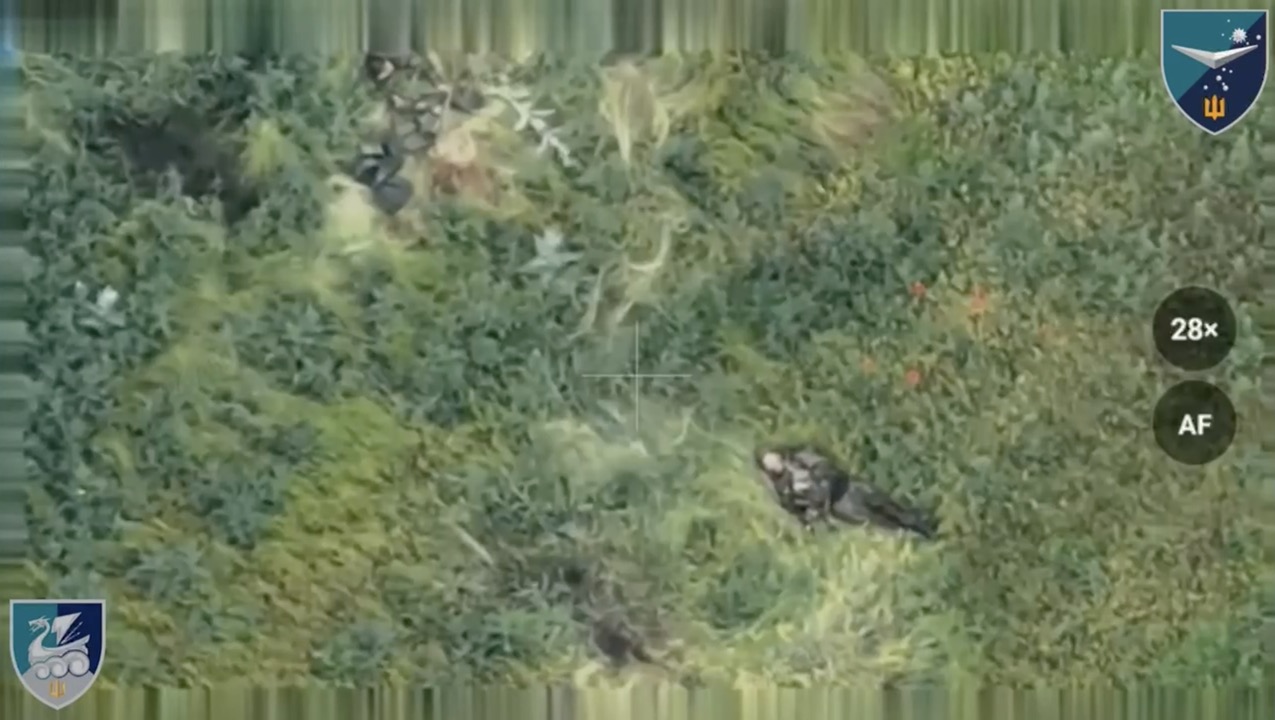 Quick cut of Russian soldier seen from above shooting himself while lying on his back in the grass