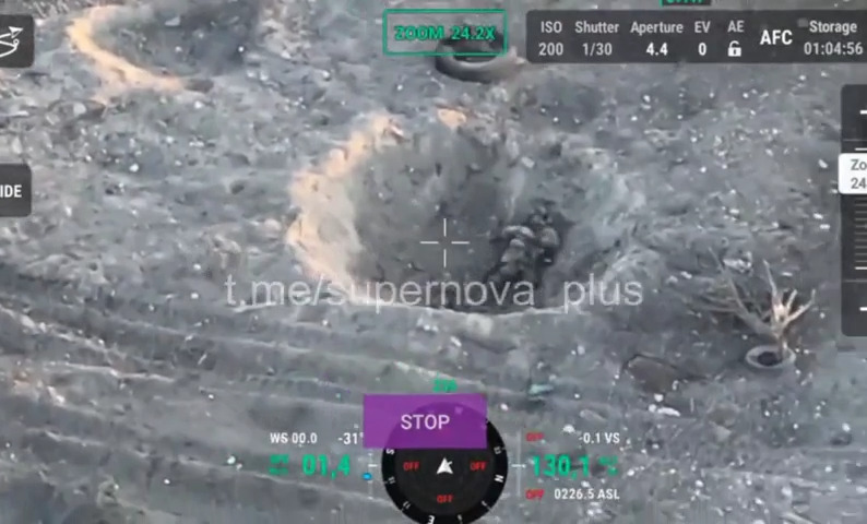 Russian soldier in shell crater appears to shoot himself