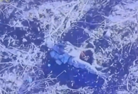 Poor quality video with Russian soldier on it lying on his back with his helmet besides him. He's pulling the trigger on his AK while it's pointed under his chin