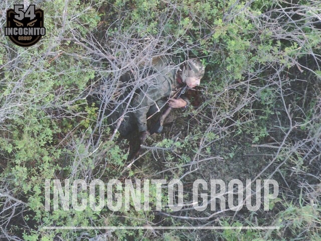Rather high quality photo of Russian soldier seen from above with no visible injury and AK pointed under his chin, it looks like he's about to pull the trigger