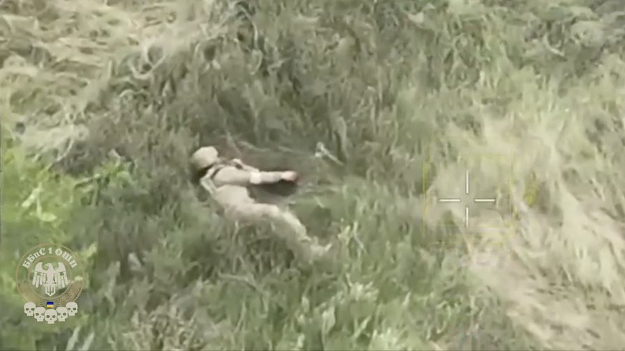 Russian is under drone drop attack in the high grass. While lying on his side, apparently injured, he grabs his AK and shoots himself