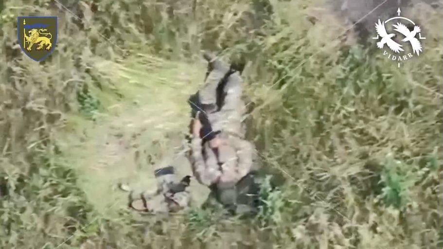 Russian shoots himself while lying on his back with AK pointing near his face as camera zooms in. The shot doesn't kill him, and the amount of damage isn't clear as he covers his face with hands and keeps moving