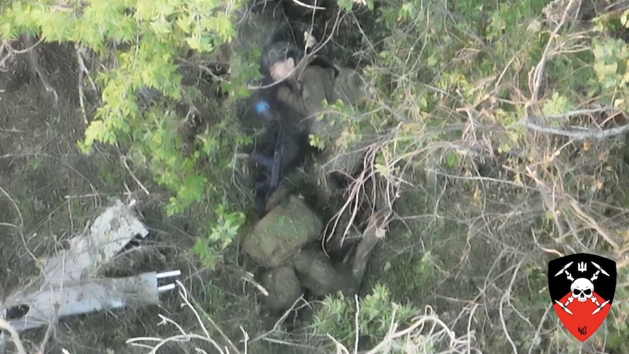 Quick video cut of fully equipped Russian shooting himself under his chin as he's lying besides what looks like his dead comrade