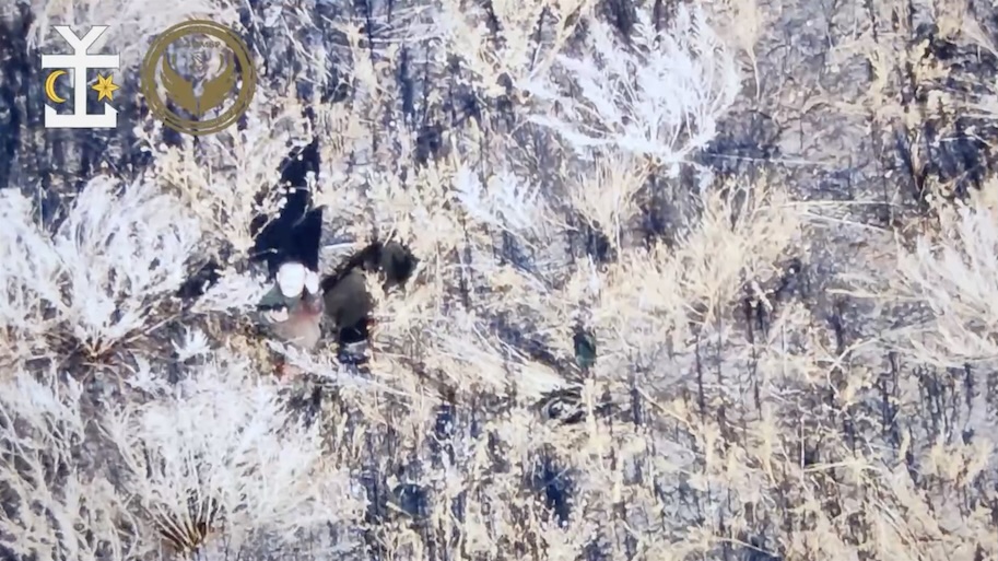 Russian is seen right from above sitting in the bushes, unclear injured or not. He takes his grenade, shows middle finger on camera, and detonates it while holding it to his chest