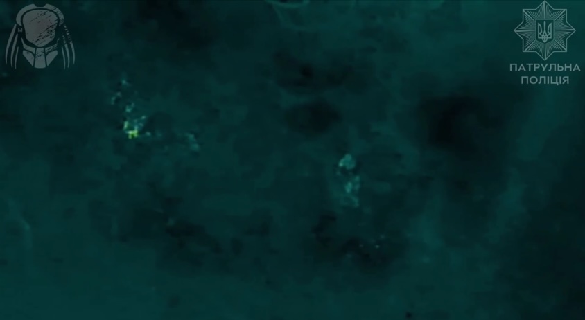 Thermal view of Russian soldier lying on his back and shooting himself while his comrade crawls away