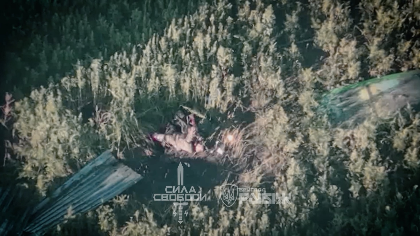 Group of Russians on motorbikes moves along the road, get under attack. One is injured, crawls off the road, receives direct FPV hit and is seen shooting himself with AK pointed at his face