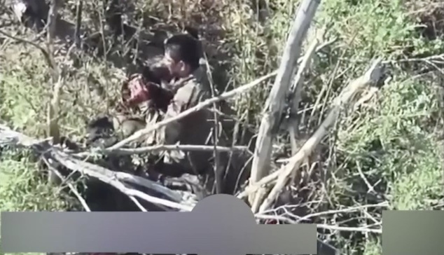 Russian with no helmet sits on the ground under the tree, pulls the pin on his grenade, and for some reason leaves it detonate behind him. Walks away with apparently minor injury only to be hit by FPV soon after