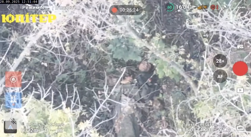Presumably injured fully equipped Russian soldier is lying on his back under the tree with grenade in his hand. After few moments of hesitation he drops it on his chest next to his face, it detonates shortly