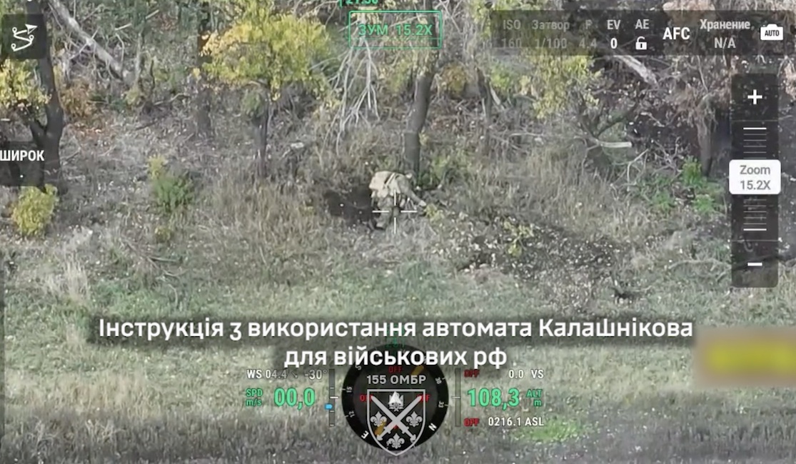 Fully equipped Russian soldier is lying under the tree in a tree line, receives close hit of unknown type, points his AK at his temple and pulls the trigger