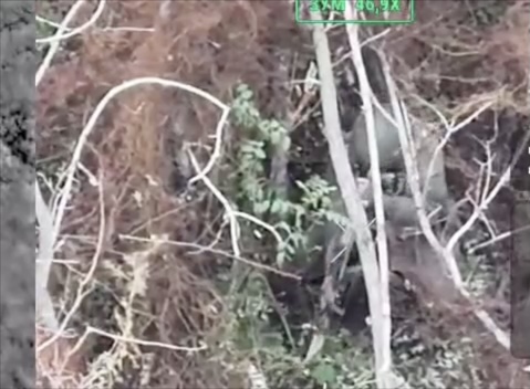 Fully equipped Russian soldier sits kneeled and fully contracted for several seconds then sits upright and shoots himself right in the face