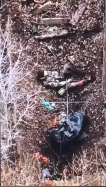 Russian is lying on his back in a ditch, he holds AK between his legs pointed under his chin and pulls the trigger. Few moments after FPV hits him