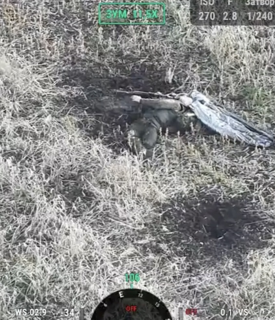 Russian is walking in the open field rather casually, receives drone drop followed by nearly direct FPV hit. Apparently injured, he grabs his AK, and points under his chin. Something isn't working, he checks it, then points again and pulls the trigger
