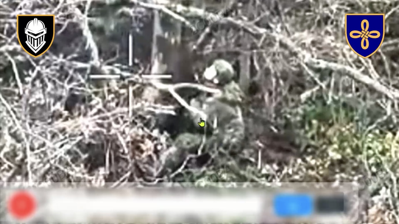 Russian is seen sitting under the tree, receives close hit. He grabs his AK, make test shot and shoots himself