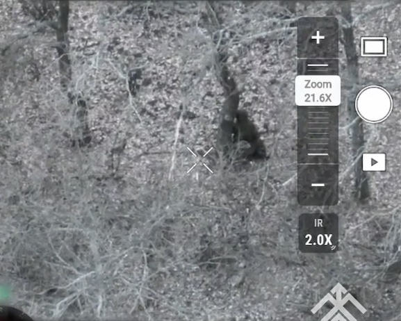 Fully equipped Russian moves along the road, looks at the sky and hides in the treeline. Shortly is seen sitting besides the tree, firing couple of test rounds and shooting himself. Closeup footage from the other side features him lying still but with no visible injury