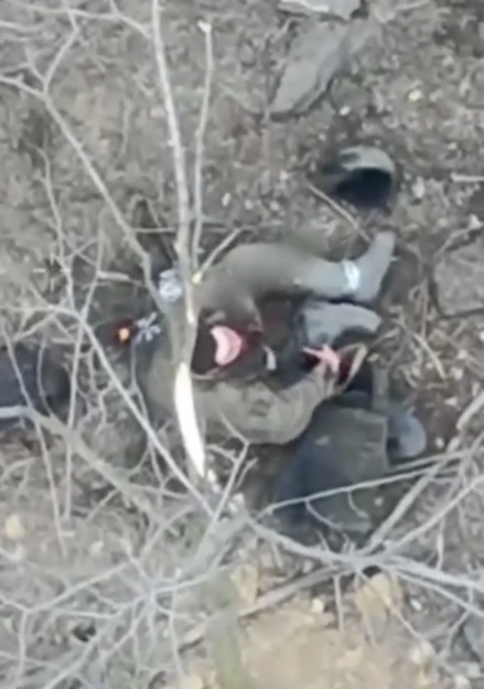 Russian is seen right from above in what looks like immediate aftermath of some attack. He points AK under his chin and seems to pull the trigger but isn't dead. Few moments later he tries again, this time killing himself with blood in sight