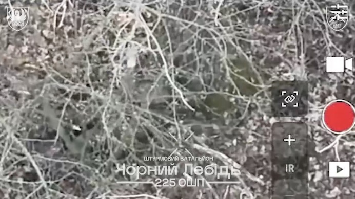 Russian soldier is being chased in a tree line by a drone, receives multiple grenade drops. Eventually is seen shooting himself in the temple