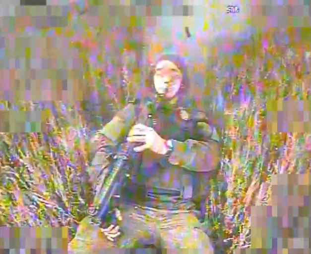 Russian soldier appears to shoot himself in the face while lying on his back in the open field as FPV approaches